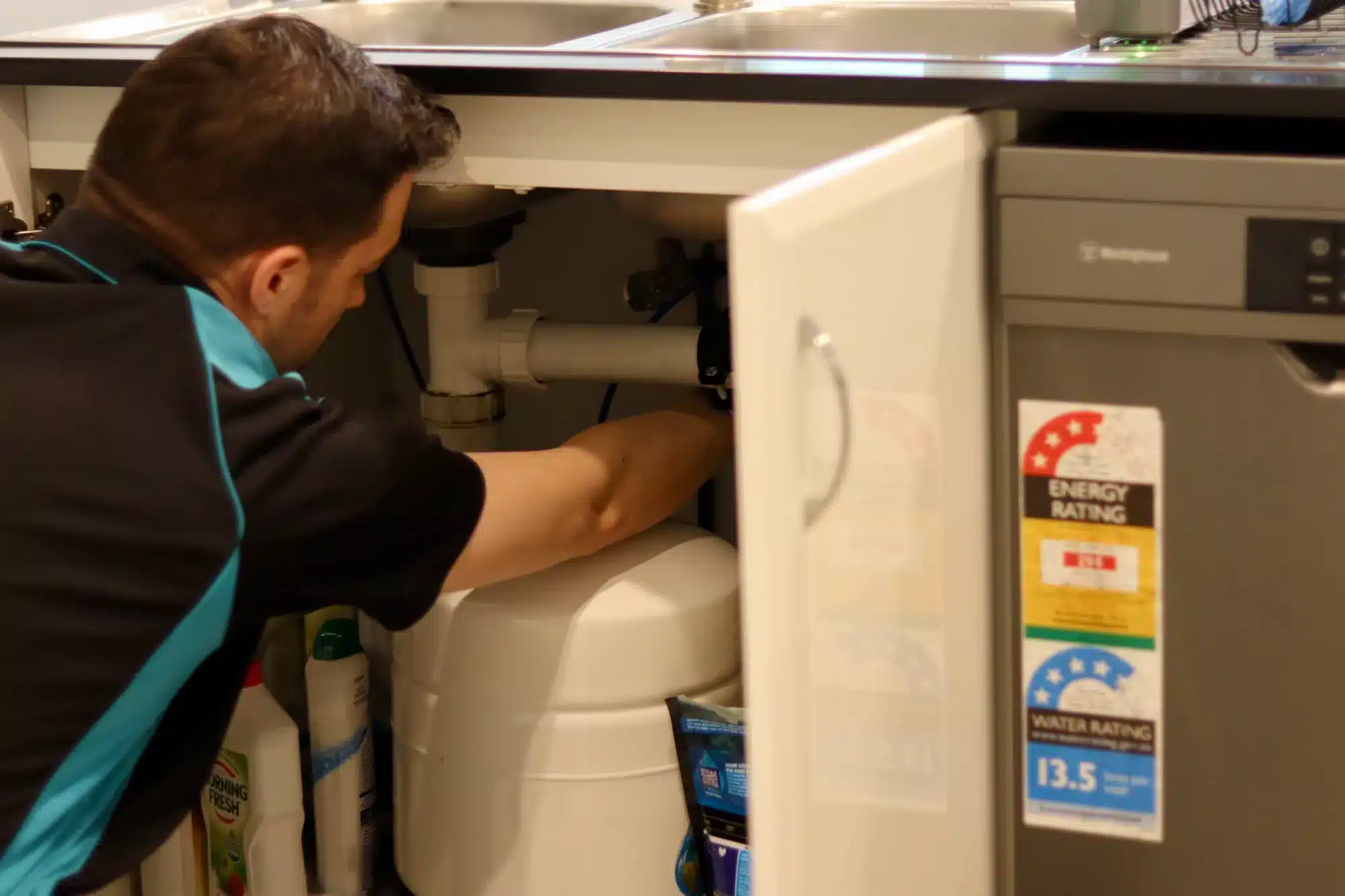 Professional plumber unblocking a drain