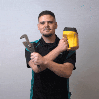 Plumber holding tools and light.