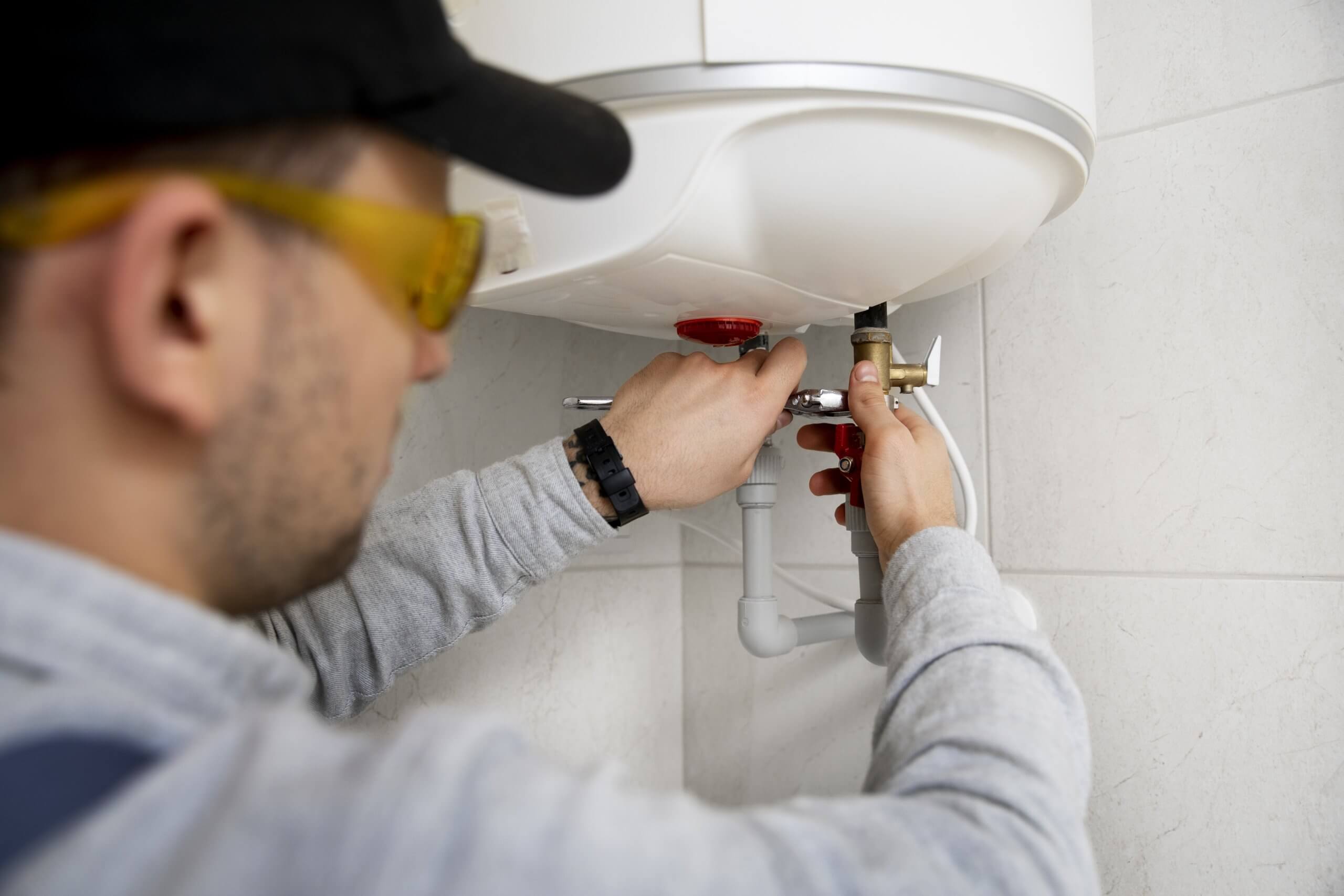 Plumber repairing water heater.