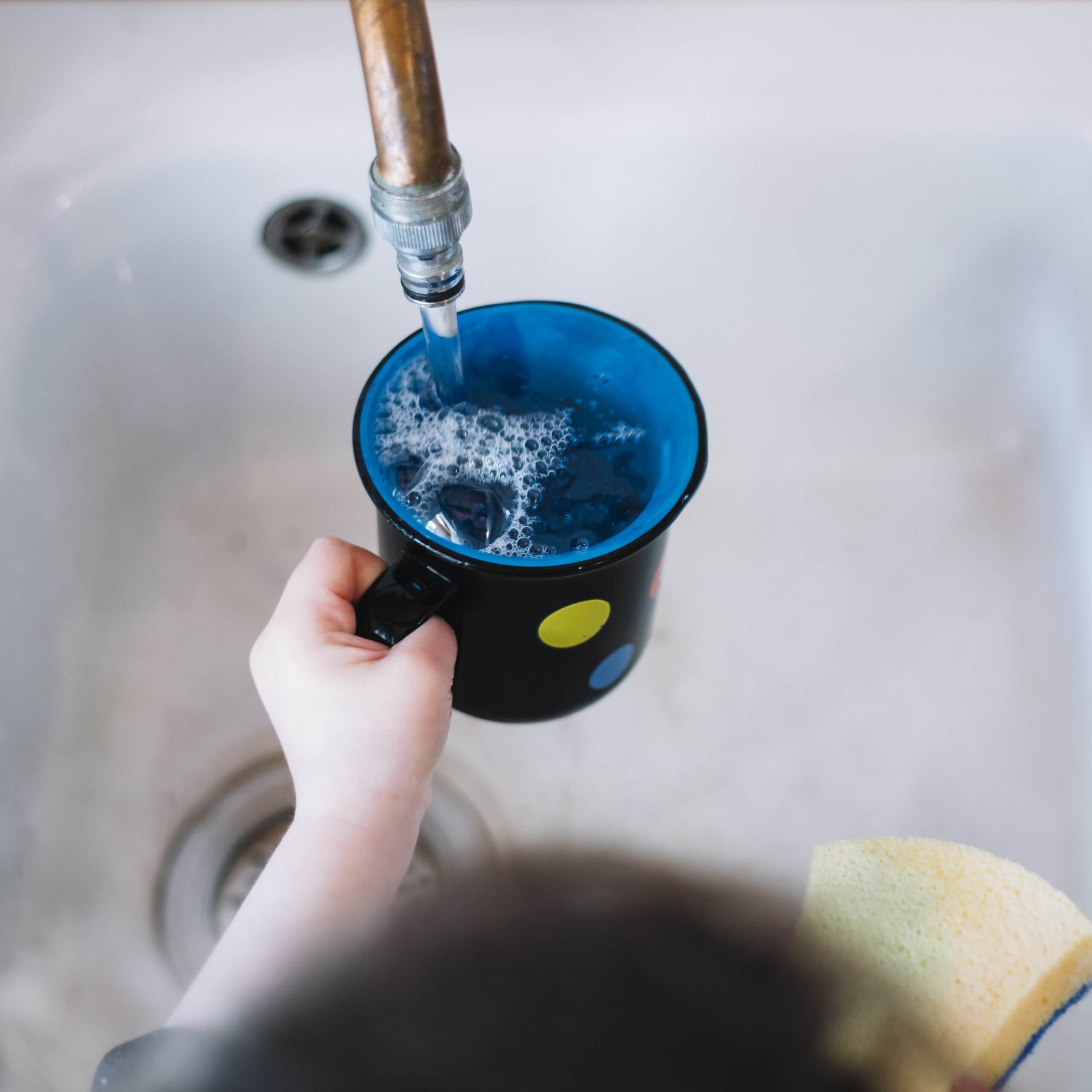 girl-s-hand-filling-cup-with-water
