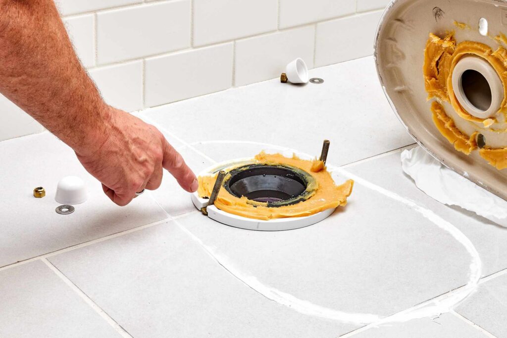 setting-a-toilet-2719046-01-0db328a65c274dc88231545451825328 Installing toilet flange and wax.